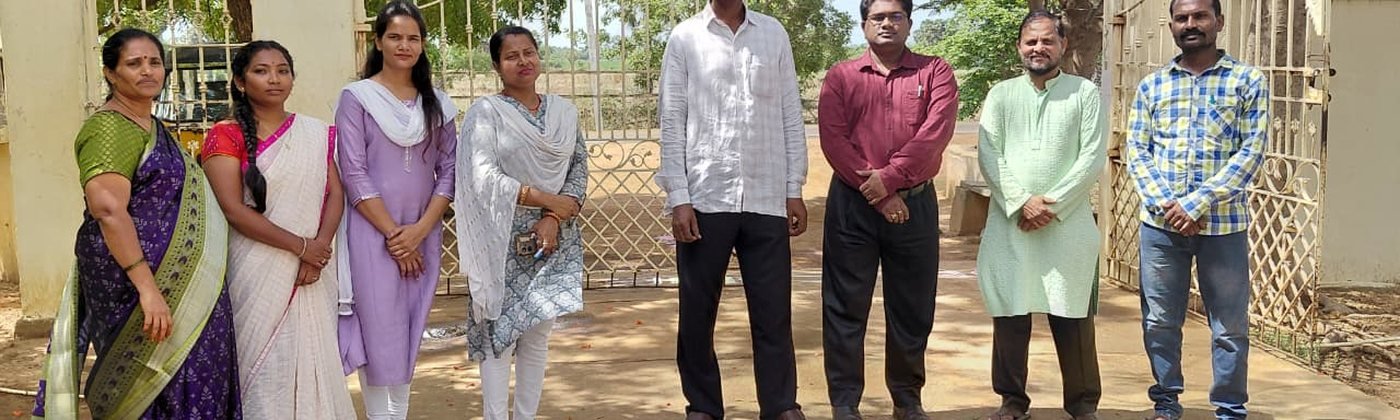 Staff standing with rangoli